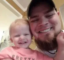 A man and his baby smiling